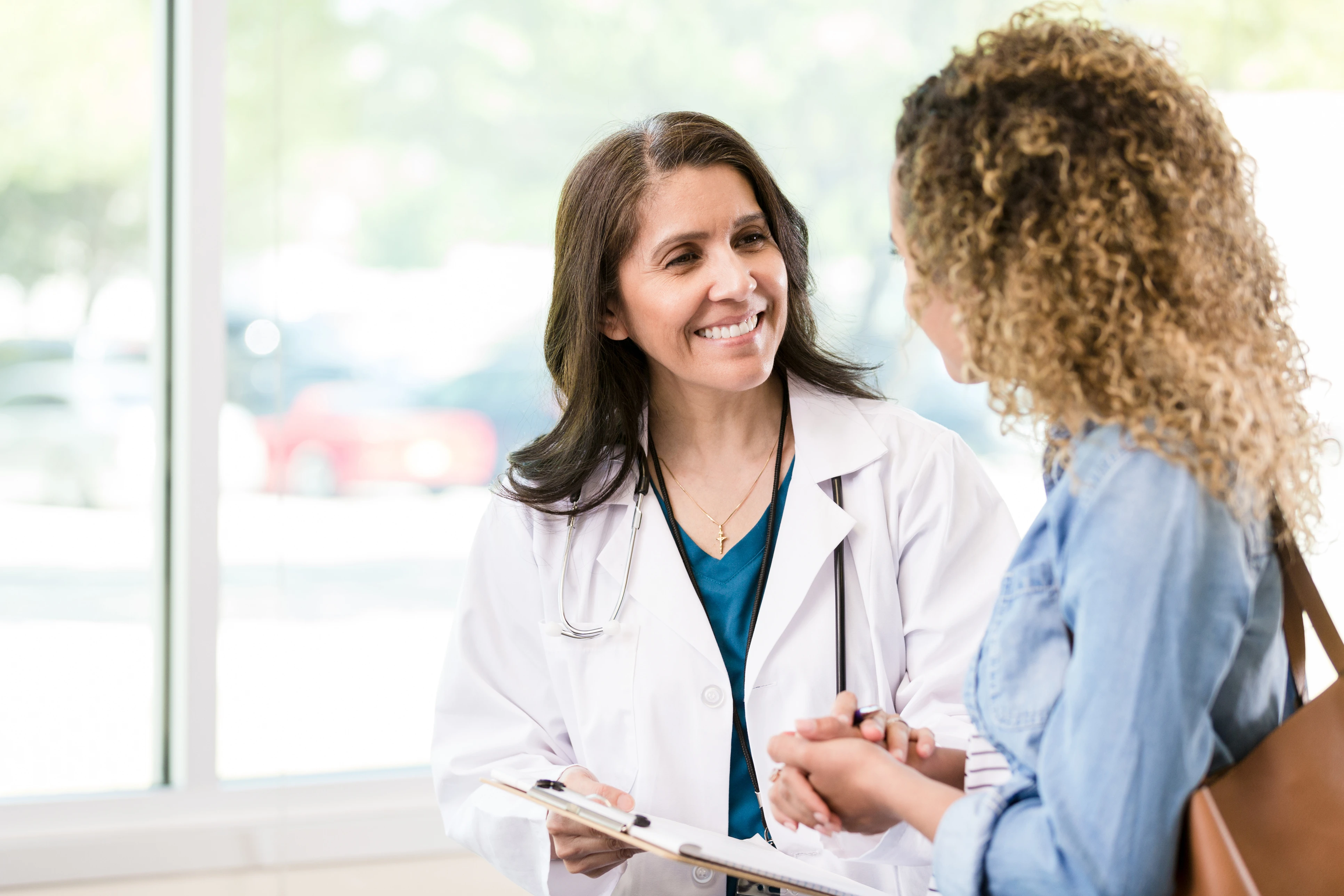 Doctor and nurse smiling at each other